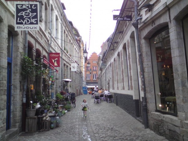 Little girl wanders through Lille street